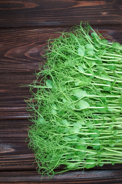 chopped microgreen pea sprouts on old wooden table