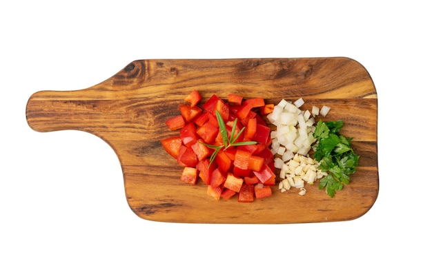 Chopped paprika with garlic and parsley on wooden board