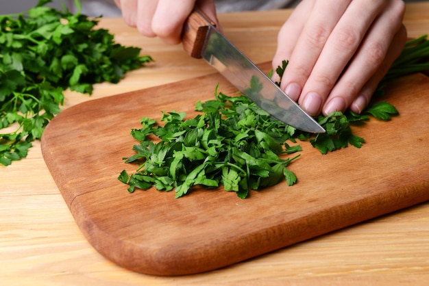 Chopped parsley on wooden board close-up