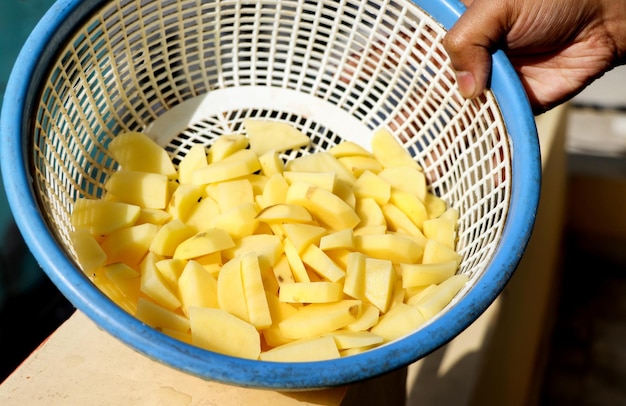 Chopped potato pieces in a plastic basket