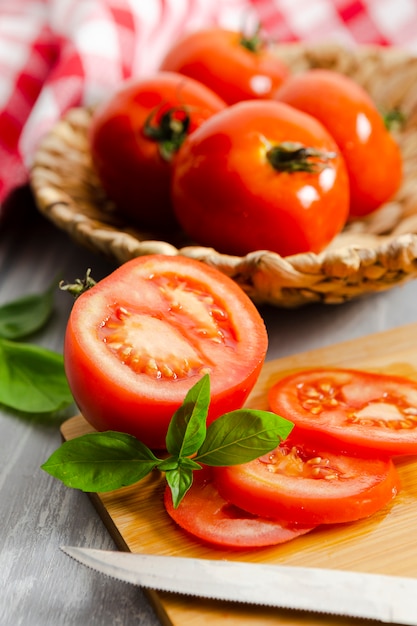 Chopped tomatoes with mint on wooden board