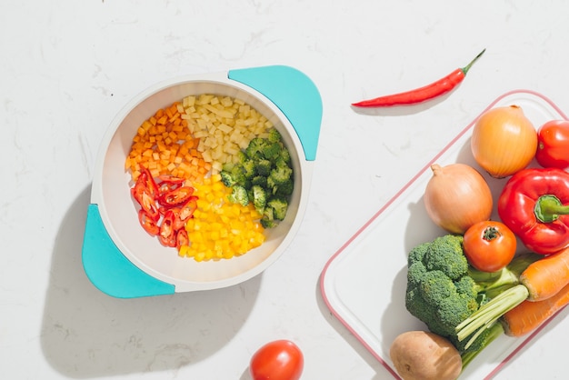 chopped vegetables on pot and ingredients for tasty vegetarian cooking