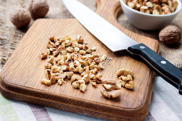 Chopped walnuts on wooden cutting board