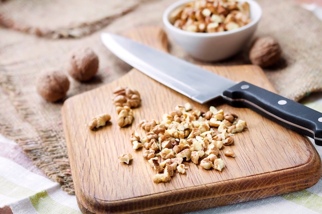 Chopped walnuts on wooden cutting board