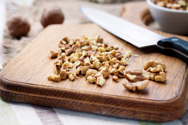 Chopped walnuts on wooden cutting board