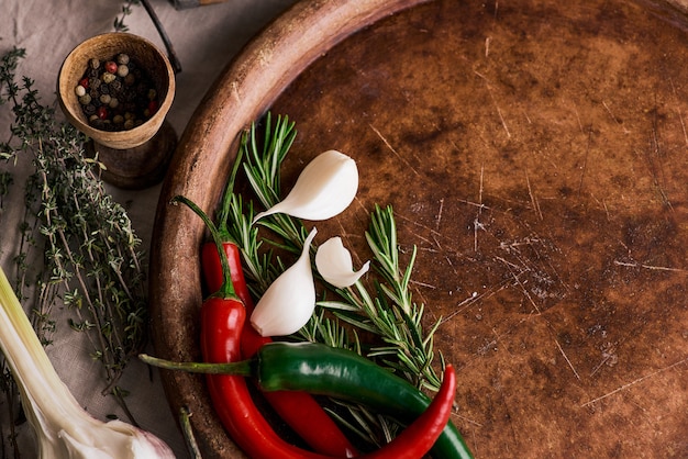 chopping cutting board, herbs and spices on a wooden background