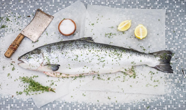 Chopping whole salmon on an old white table