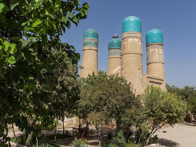 Chor Minor Madrassah ancient building with minarets against clear blue sky Bukhara Uzbekistan