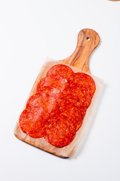 Chorizo sausage and salami, thin cut. Spanish salami on the wood background