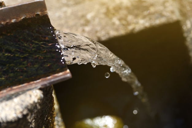 Chorus of spring water flowing in an old rustic village fountain