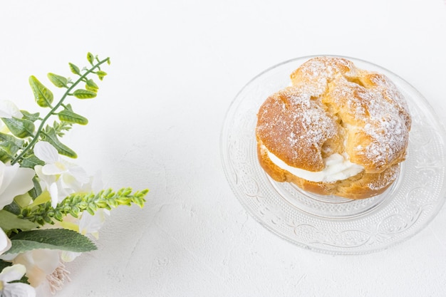 Choux Bun dessert on plate French pastry white background copy space