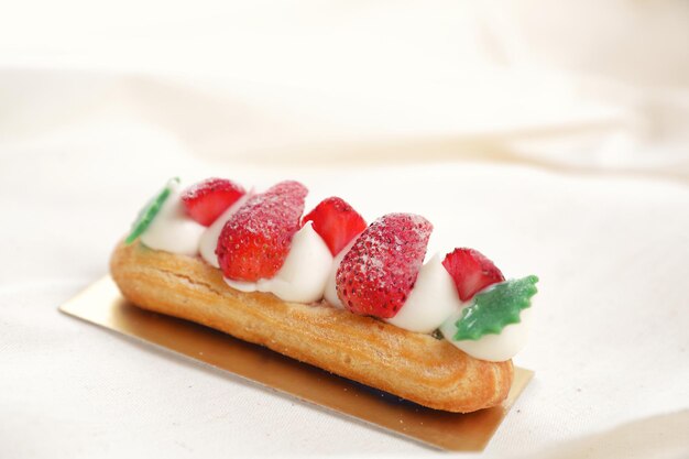 Choux cream with strawberry isolated in white background