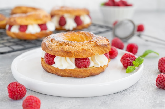 Choux pastries Choux rings with cream of cream cheese or cottage cheese and fresh raspberries