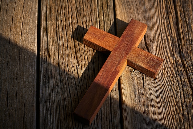 Christian cross on wood over wooden