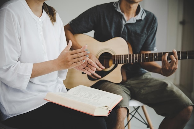 Christian family groups praying with Holy Bible