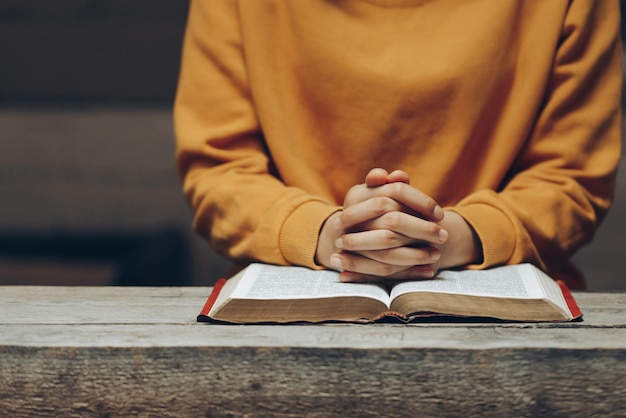 Christian life crisis prayer to god praying hands young woman prayer with hands together over Bible