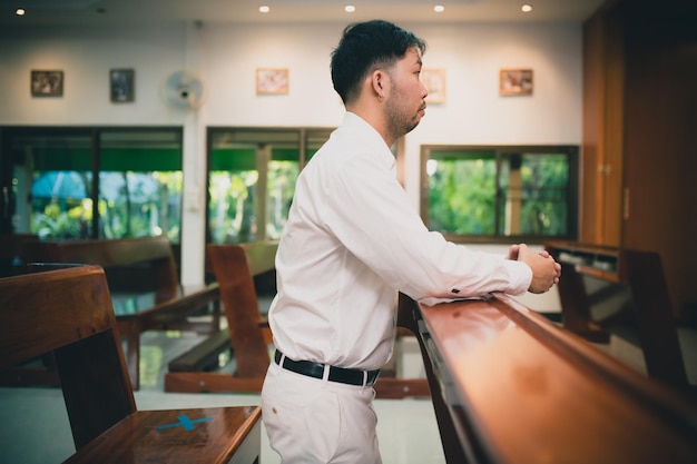 Christian man asking for blessings from GodAsian man praying to Jesus Christ