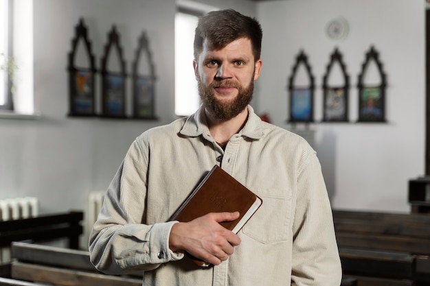 Christian man holding bible medium shot