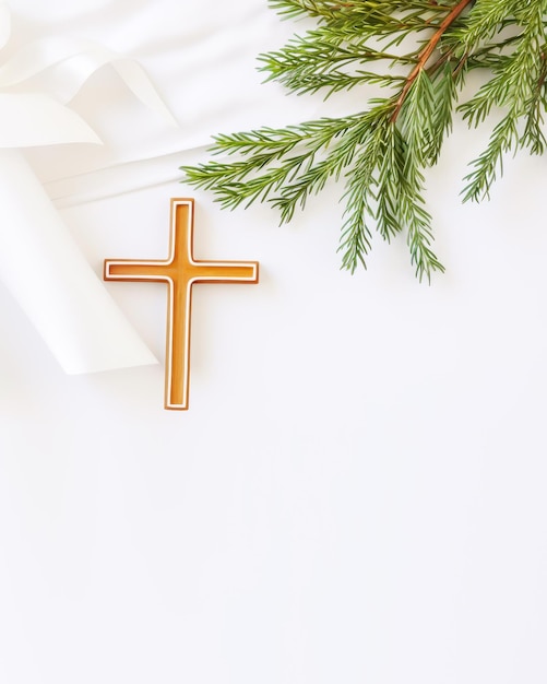 Christianity wooden cross with silk ribbon and green fir branch on white background with copy space