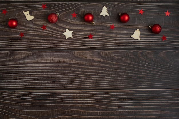 Christmas accessories on a dark wooden background. Space for design and text.