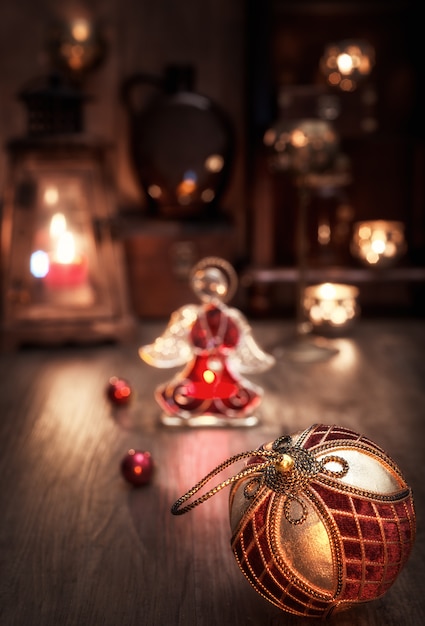 Christmas arrangement with candles, bauble and glass angel