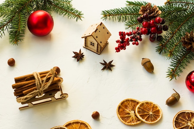 Christmas backdrop with traditional New Year's organic ingredients-slices of dried orange, cinnamon, anise stars and wooden toys.