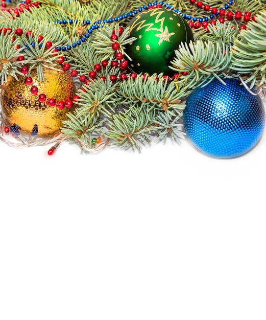 Christmas background. Branch of fir with christmas toys and garland on the white background