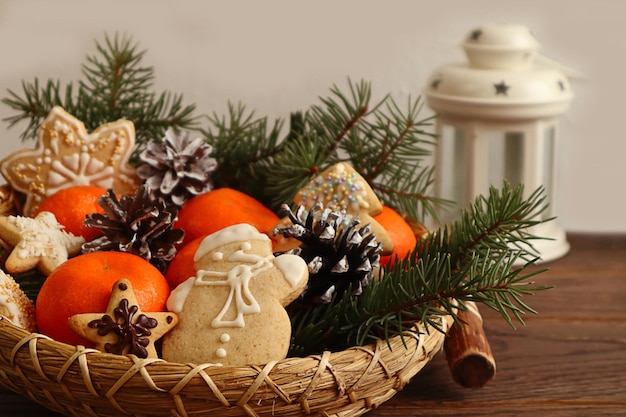 Christmas background Christmas gingerbread pine branches tangerines in decorative dishes against a white lantern light background space for text