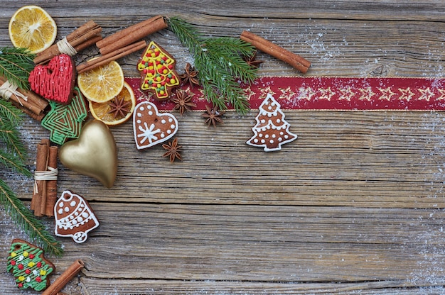 Christmas background christmas tree homemade gingerbread cookies golden heart cinnamon sticks on old