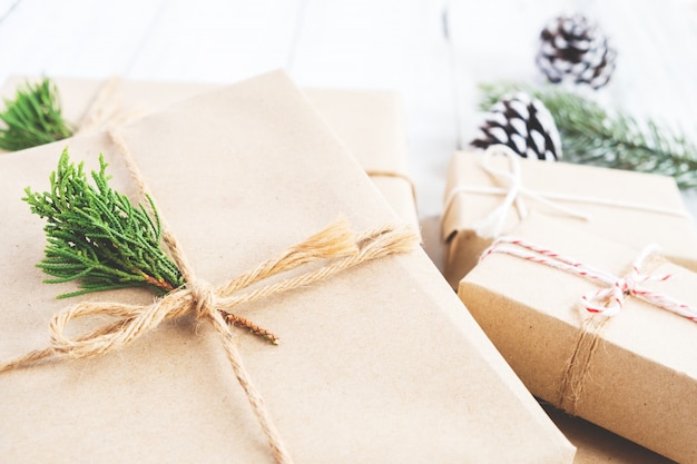 Christmas background - Craft and handmade Christmas present (gift boxes) and rustic decoration. Vintage style. Selective focus and shallow.