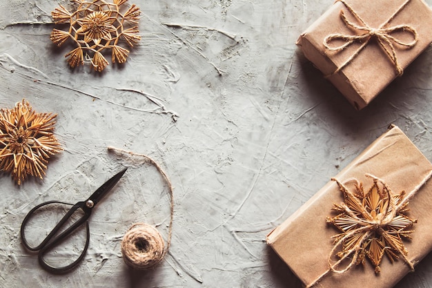 Christmas background. Gifts wrapped paper, natural decorations, spruce cones.