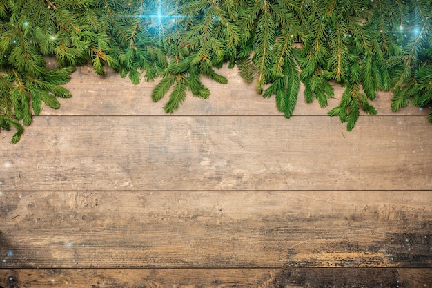 Christmas Background template Frame made fir tree branches with stars on brown wooden table Fir branch with Christmas decorations Festive Christmas Composition on old wooden background