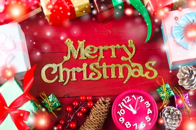 Christmas background with decorations and gift boxes on wooden board