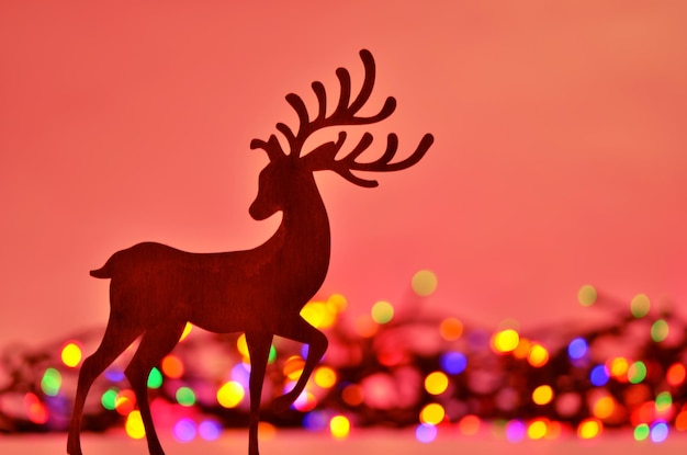 Christmas background with deer silhouette