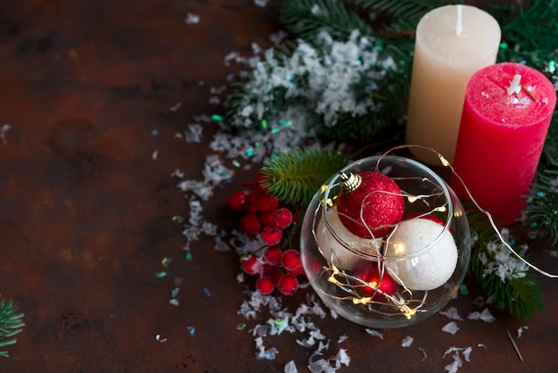 Christmas background with festive decoration, candles, light and balls in jar. 