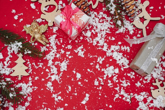 Christmas background with fir branches, pinecones, gift box. Top view.