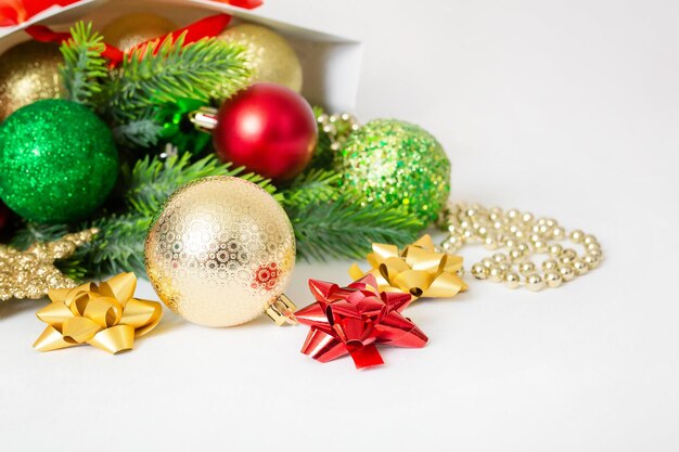 Christmas background with fir branches red and gold decorations on a white background Flat lay