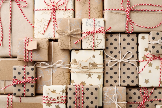 Christmas background with gift boxes wrapped in brown kraft paper flat lay.