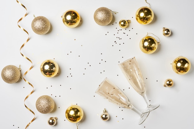 Christmas background with golden colored decorations on white