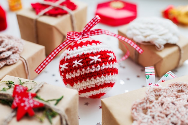 Christmas  background with presents, decorations and crocheted handmade decorative ball.