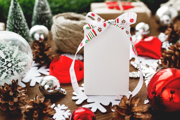 Christmas background with presents, ribbons, balls and different red decorations on wood