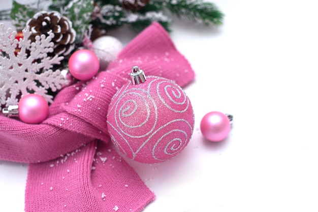 Christmas background with spruce branches and pink Christmas tree toys