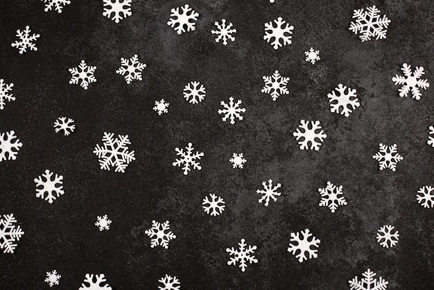 Christmas background with white snowflakes on dark background