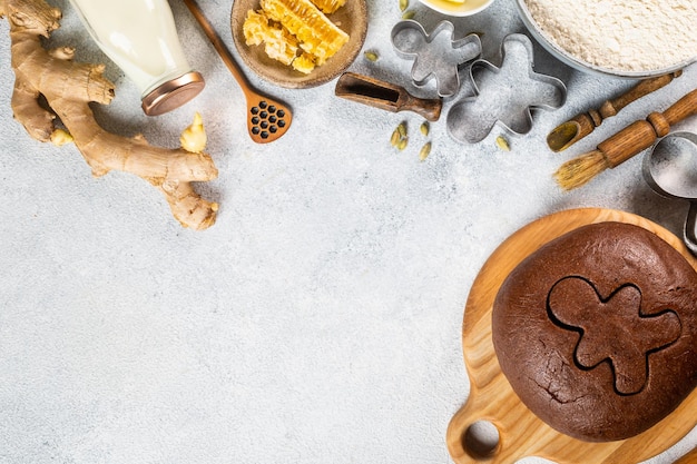 Christmas Baking background. Ingredients for cooking christmas baking on light background. Top view with copy space. Gingerbread cookies. Baking Ginger cookies. Raw dought for cookies