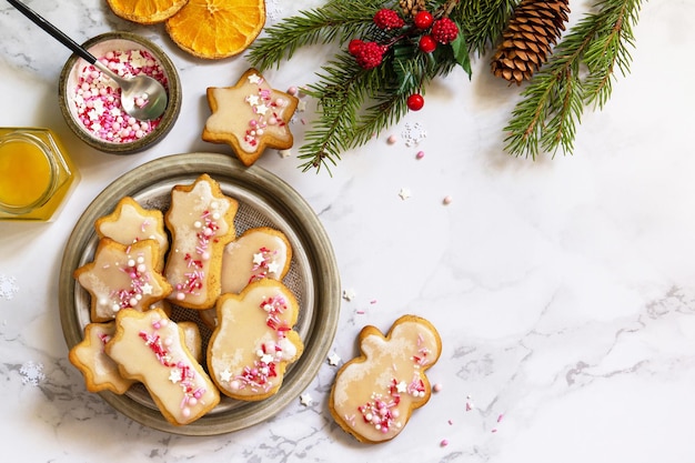 Christmas baking Homemade gingerbread cookies with glaze on a marble countertop