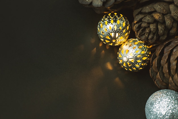 The christmas ball and Pine cones  on black  background.