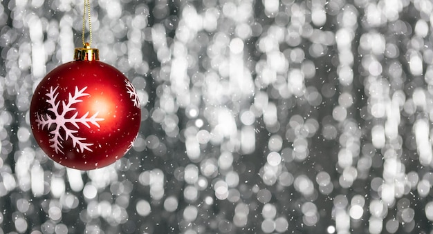 Christmas ball and snow in the night abstract bokeh lights background