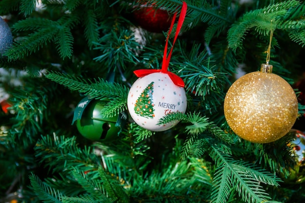 Photo christmas ball with bells on the tree to celebrate christmas and new year