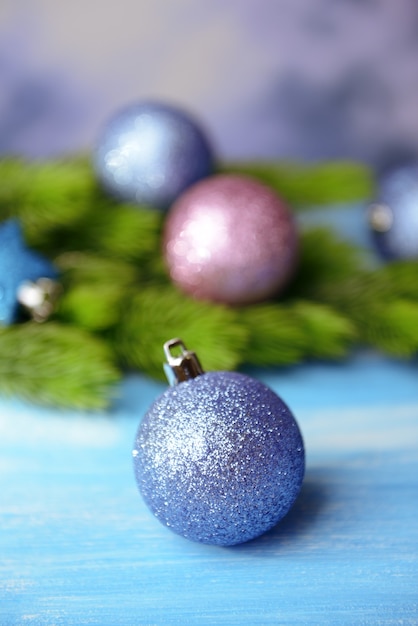 Christmas balls on fir tree, on color background