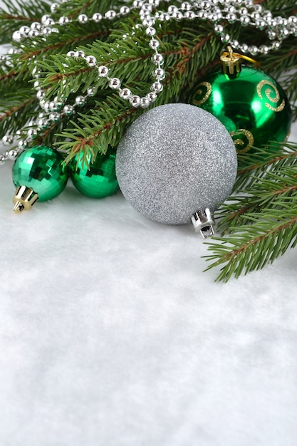 Christmas balls and garland on a spruce branch for decoration